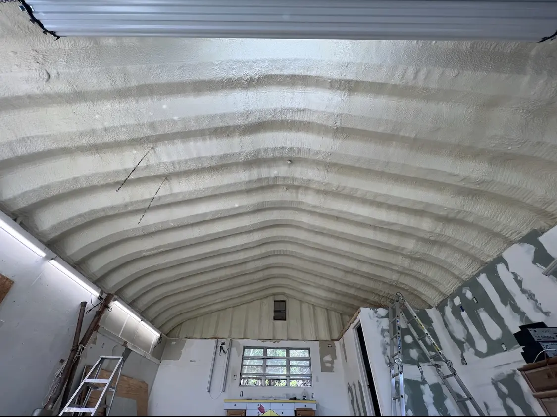 Spray polyurethane foam applied to the underside of a metal roof deck in Lisbon